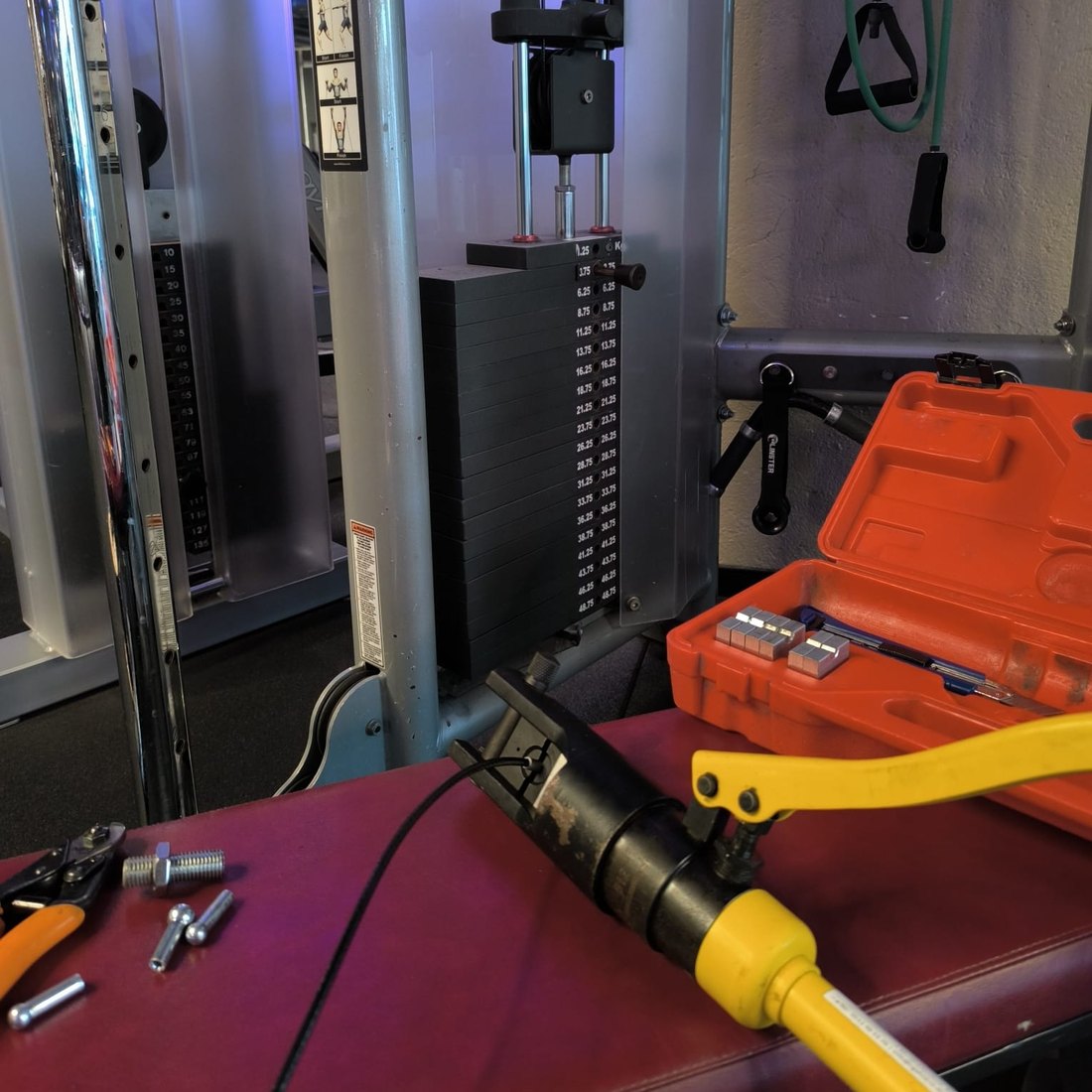 Cable on a strength machine being replaced, swaging tool and ferrules ready