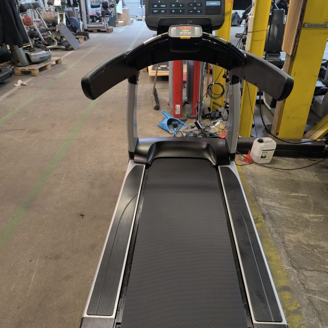 Repaired treadmill on its test run, console showing the data from the trial